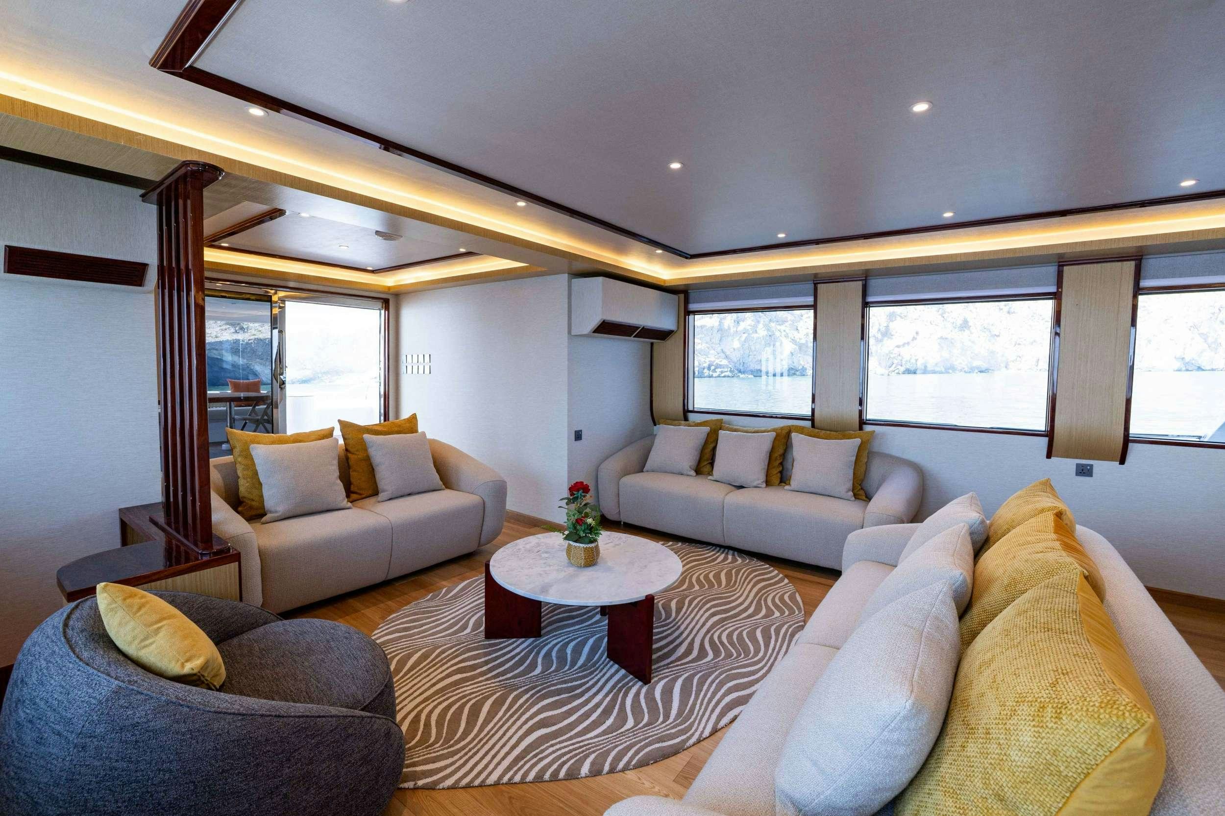 a living room with couches and a table aboard VISION Yacht for Charter