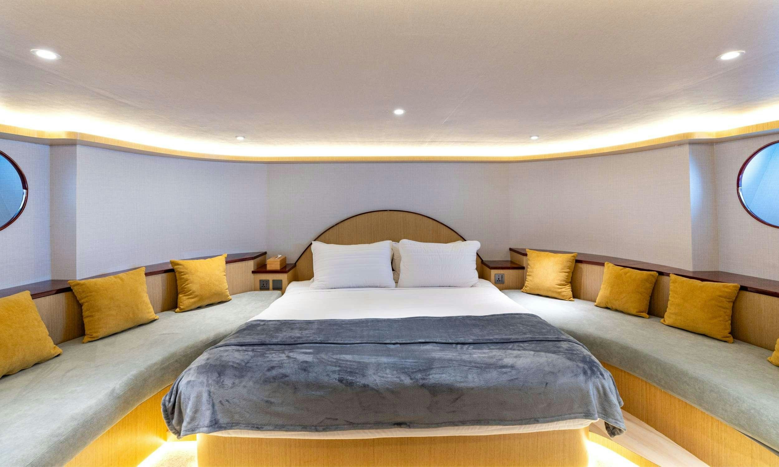 a couple of beds in a hotel room aboard VISION Yacht for Charter