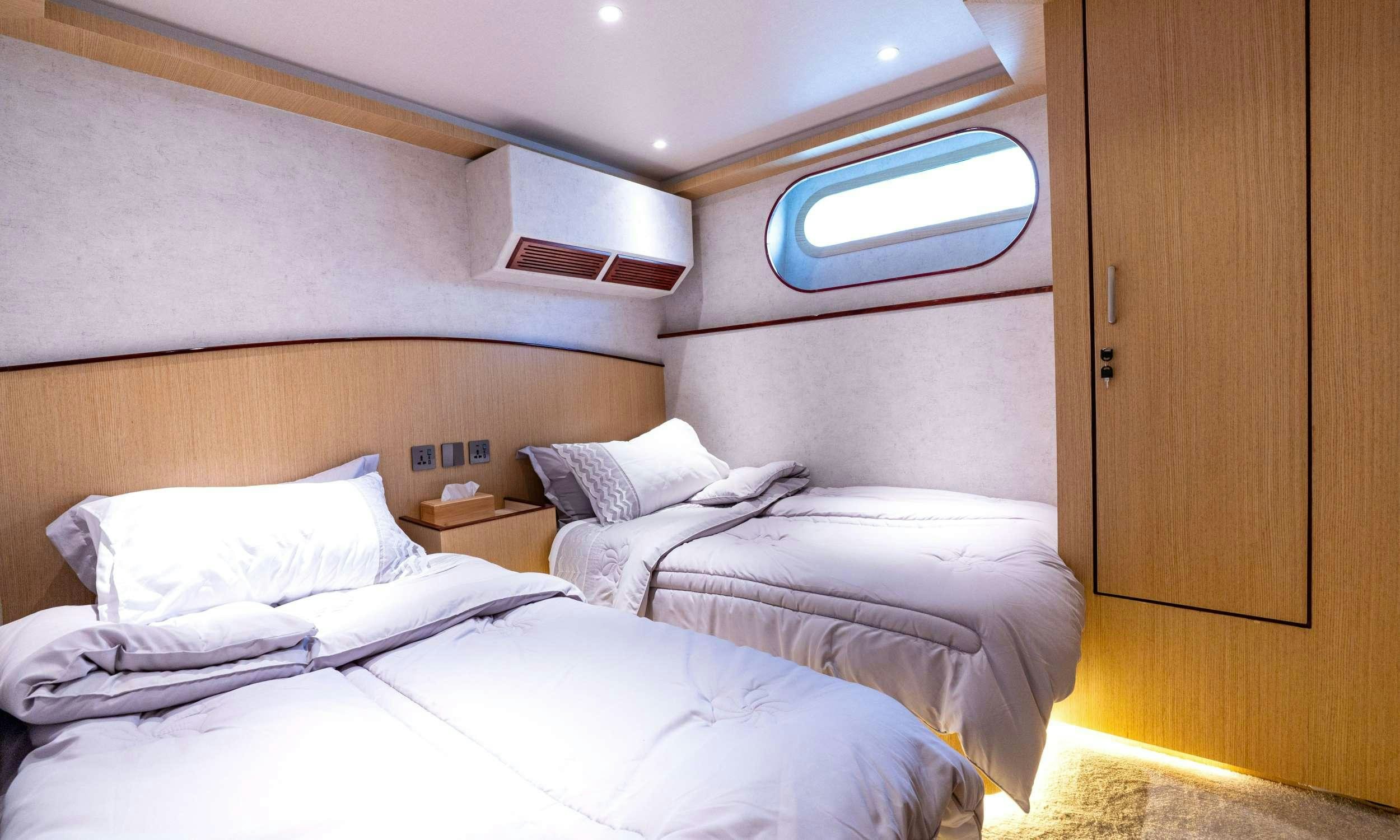a room with three beds aboard VISION Yacht for Charter