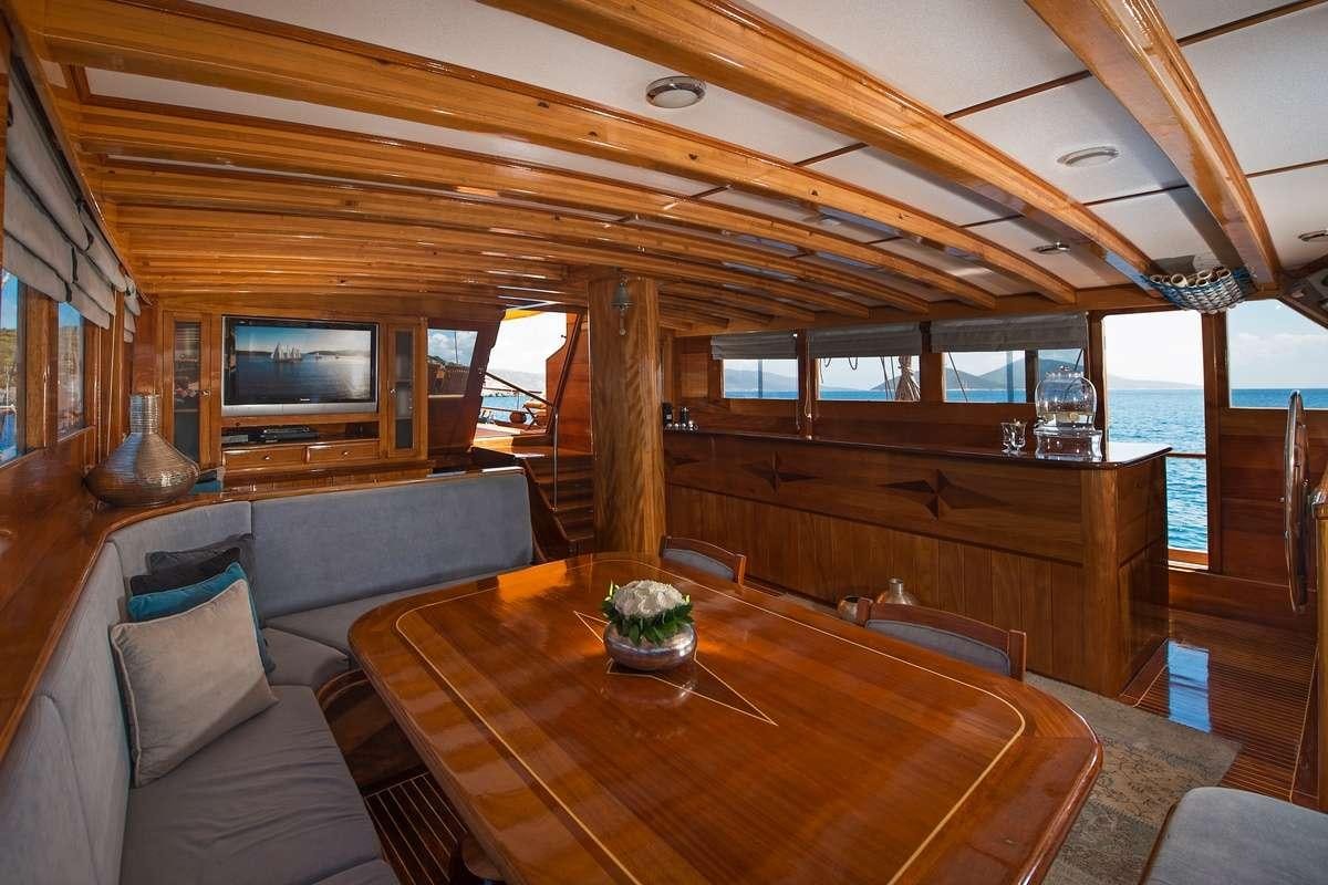 a living room with a couch and a television aboard PARSS Yacht for Charter