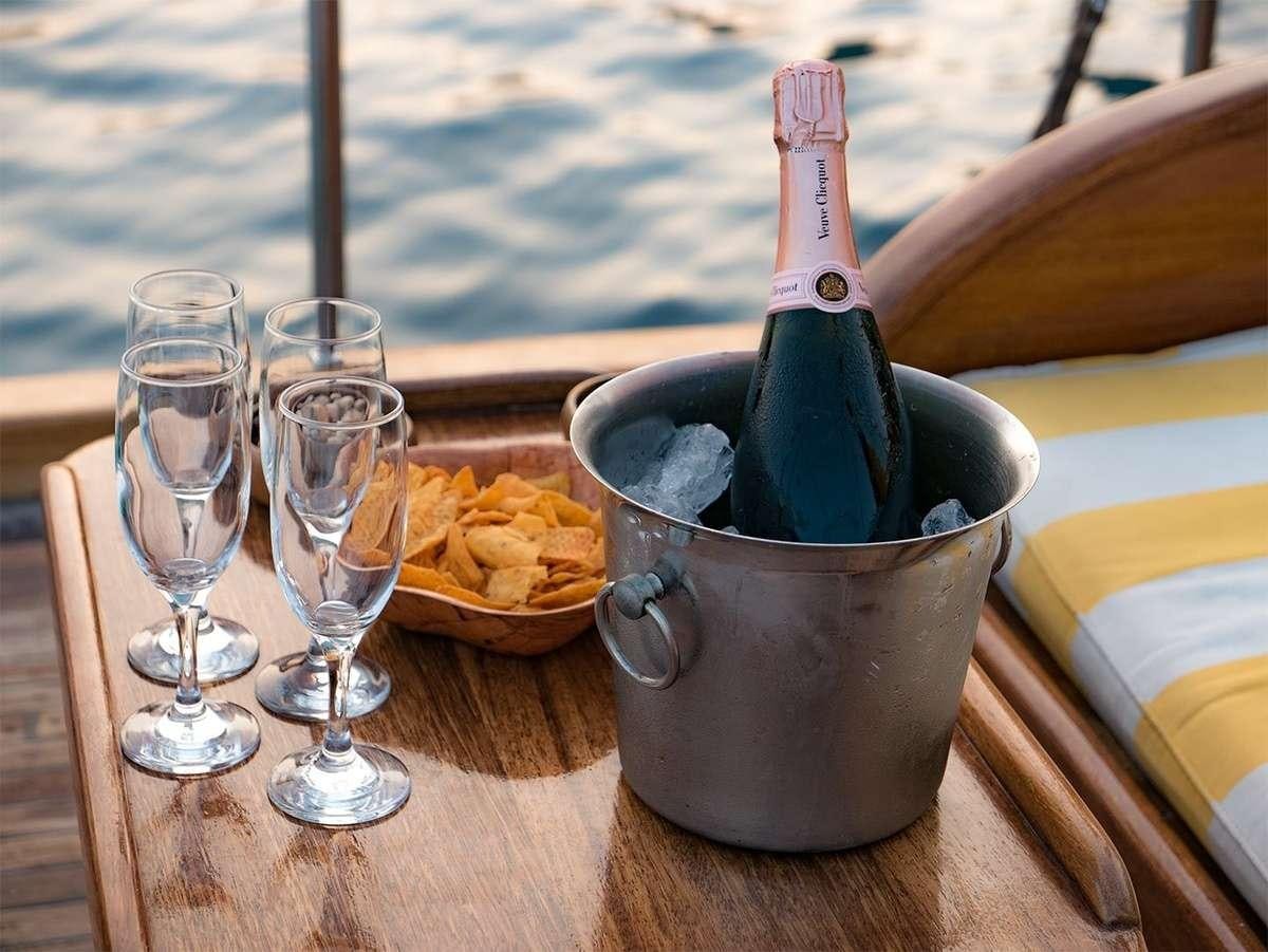 a bottle of nail polish next to a glass of wine and a bottle of wine aboard PARSS Yacht for Charter