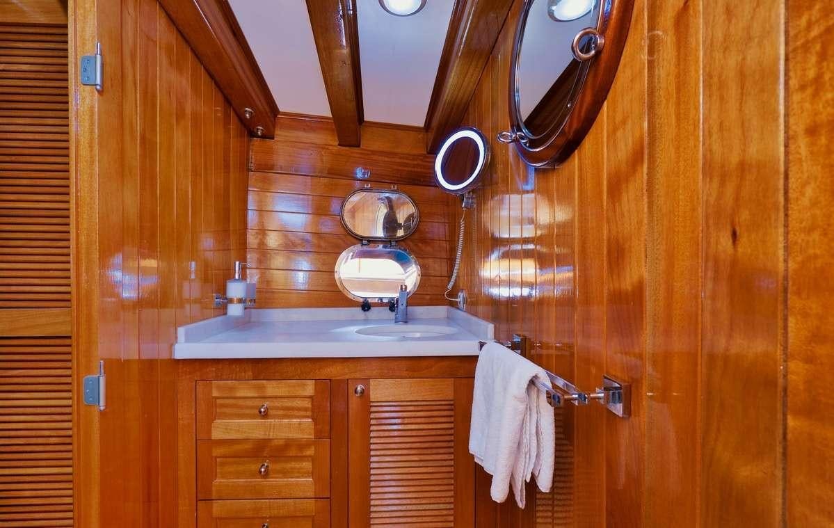 a bathroom with a sink and a mirror aboard PARSS Yacht for Charter