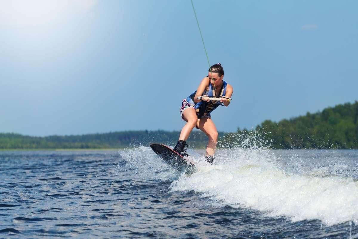 a man kite surfing on the water aboard FORTUNA Yacht for Charter