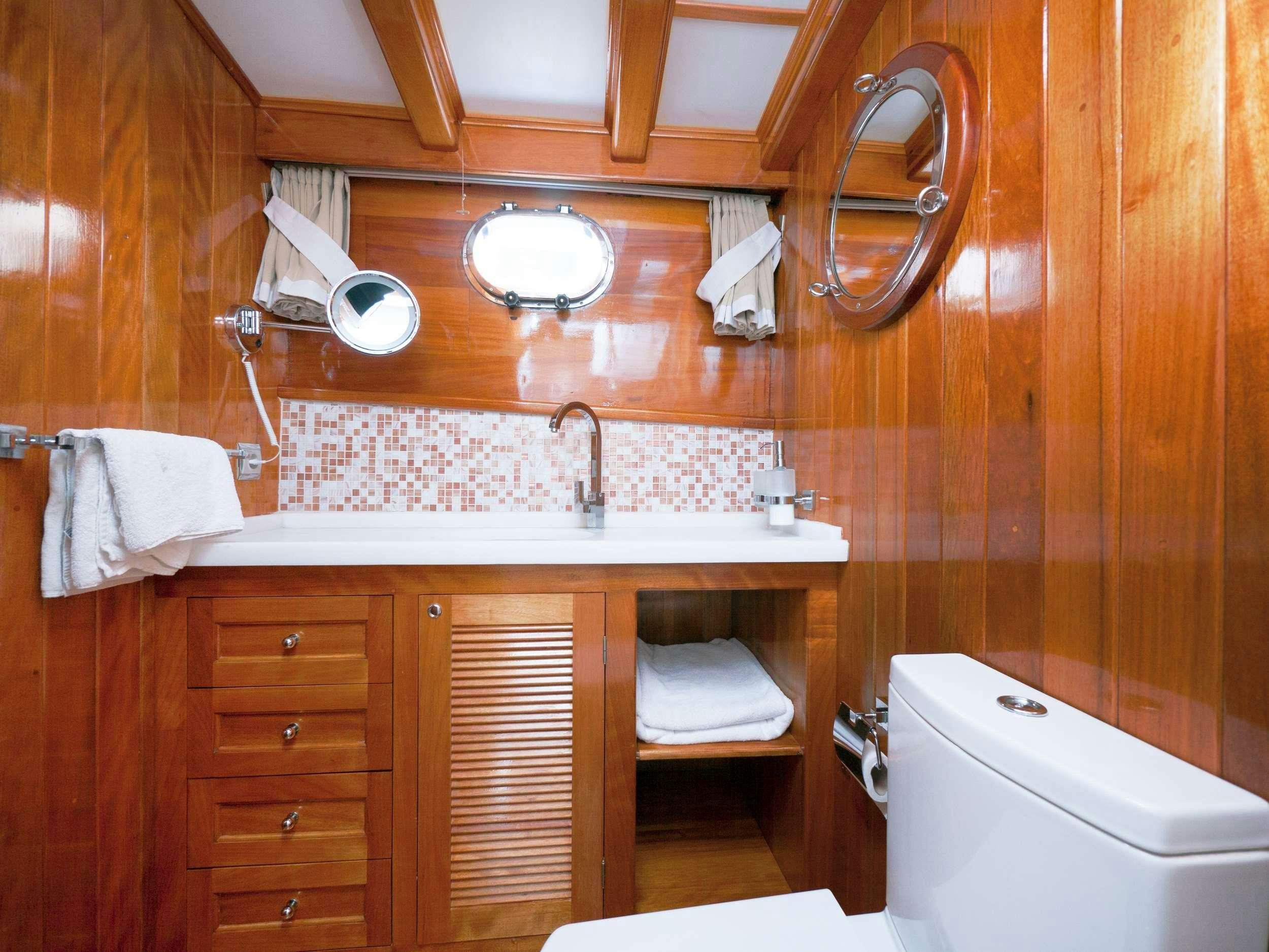 a bathroom with a sink and a toilet aboard FORTUNA Yacht for Charter
