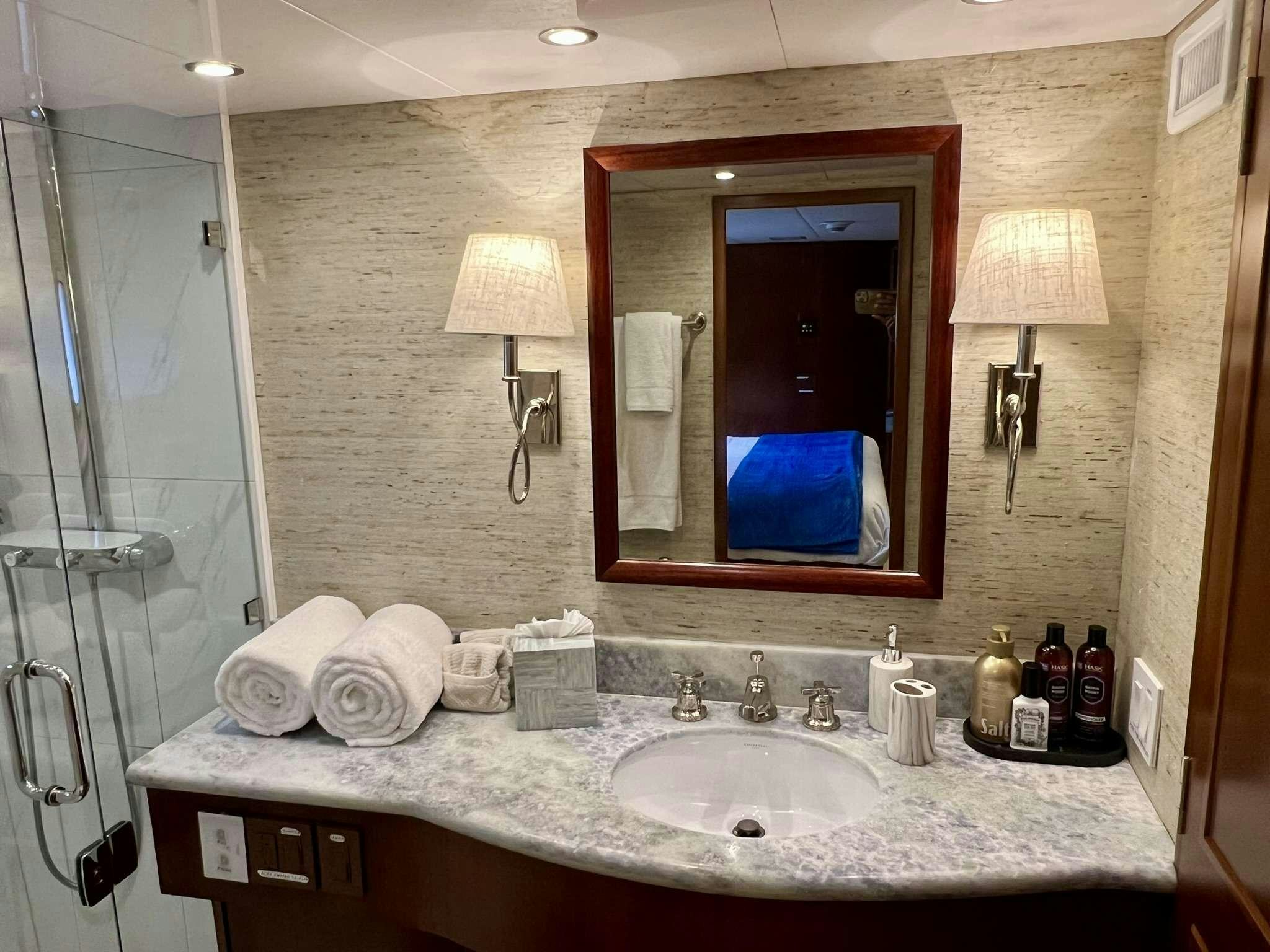 a bathroom with a large mirror aboard ESCAPE Yacht for Charter