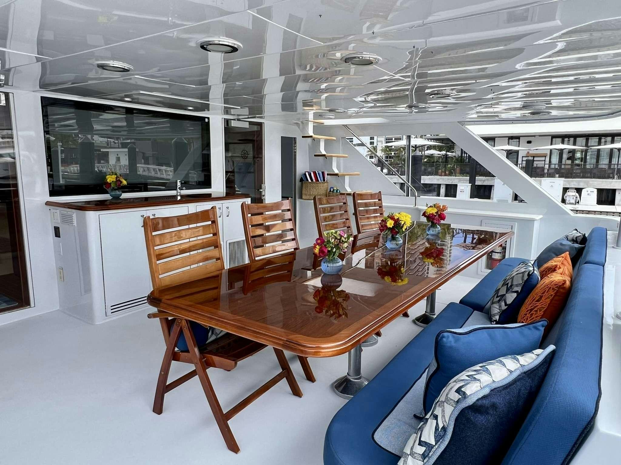 a large room with a table and chairs aboard ESCAPE Yacht for Charter