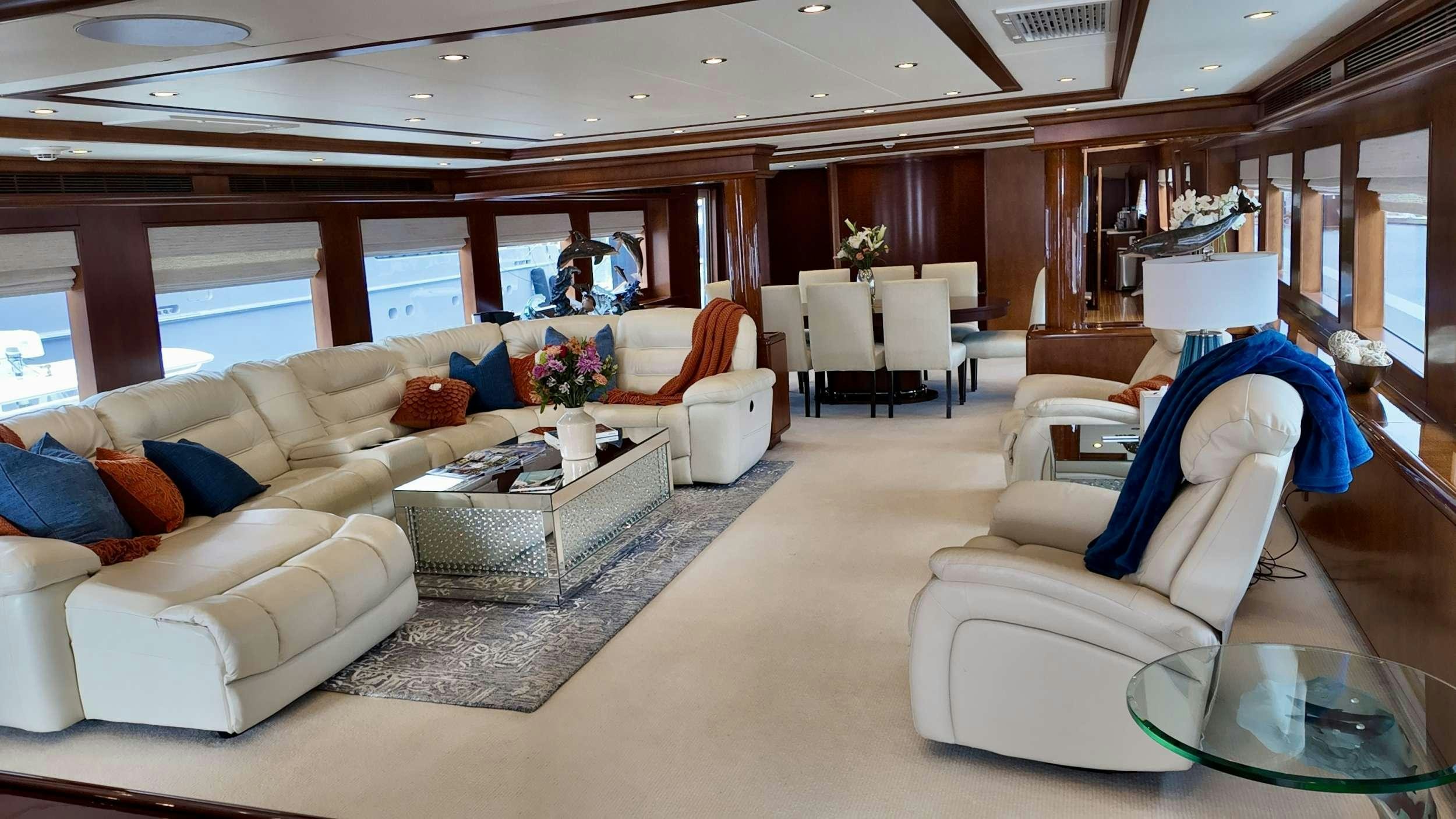 a living room with a couch and a table aboard ESCAPE Yacht for Charter