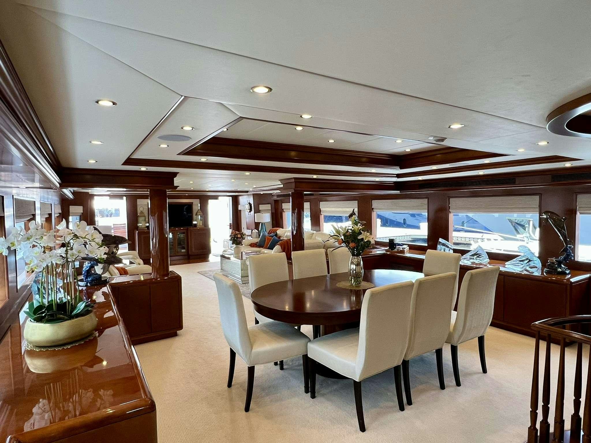 a large room with tables and chairs aboard ESCAPE Yacht for Charter