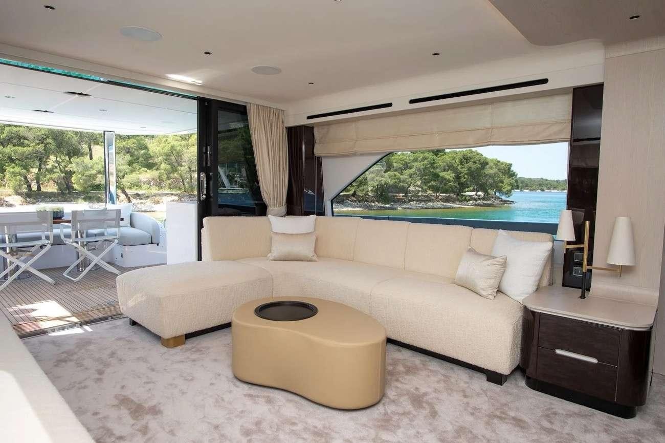 a living room with a couch and a table aboard PREWI Yacht for Charter