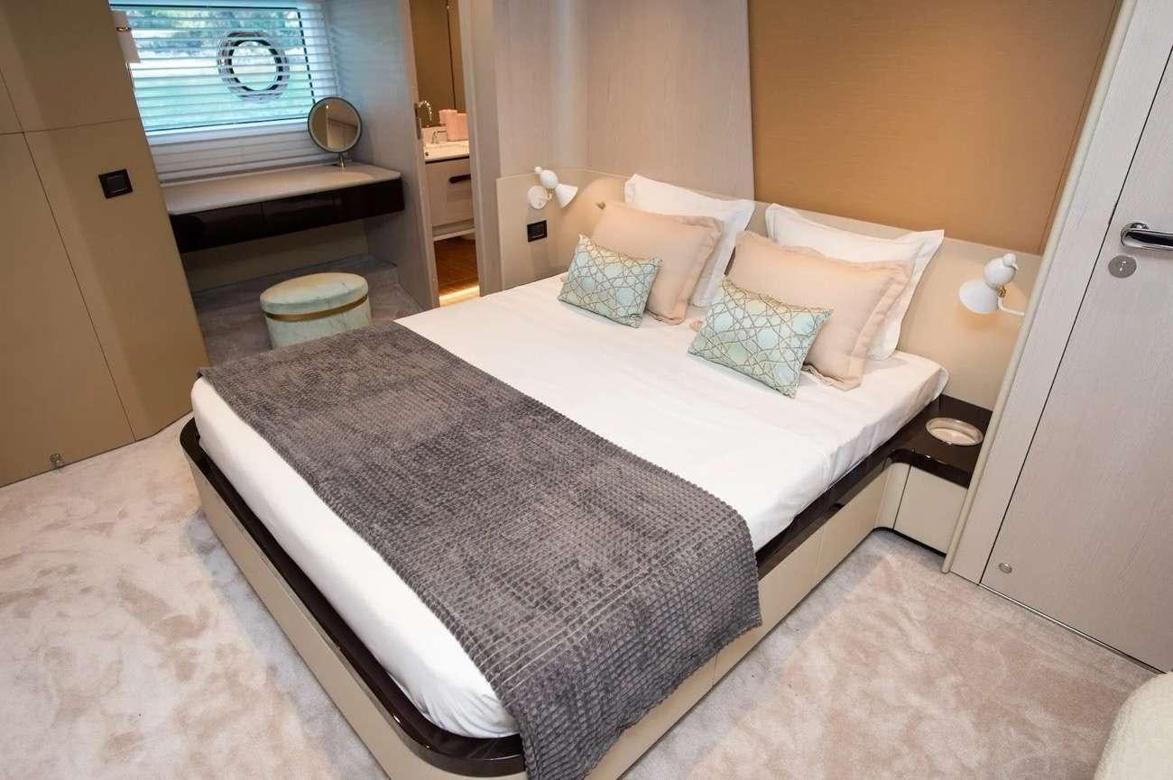 a bed with white sheets aboard PREWI Yacht for Charter