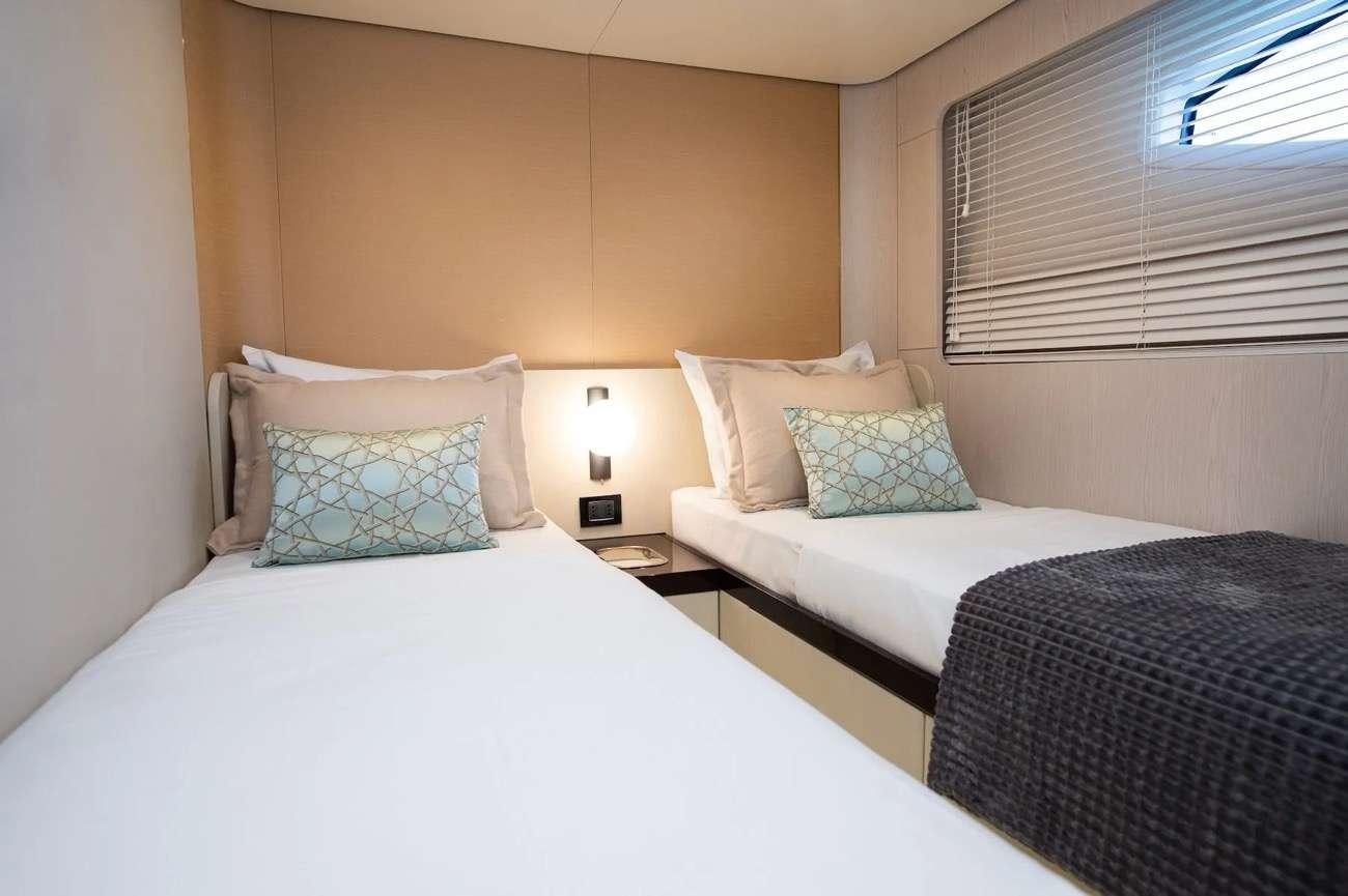 a couple of beds in a hotel room aboard PREWI Yacht for Charter