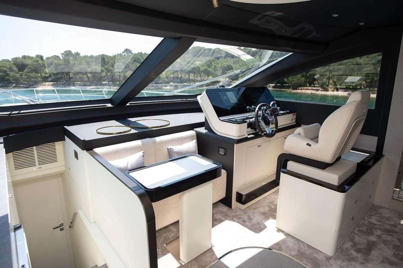 a car with a desk and a chair in it aboard PREWI Yacht for Charter
