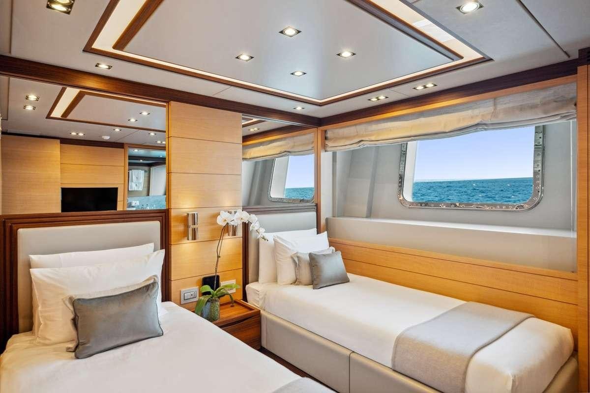 a room with a bed and a window aboard BOMBAY Yacht for Charter