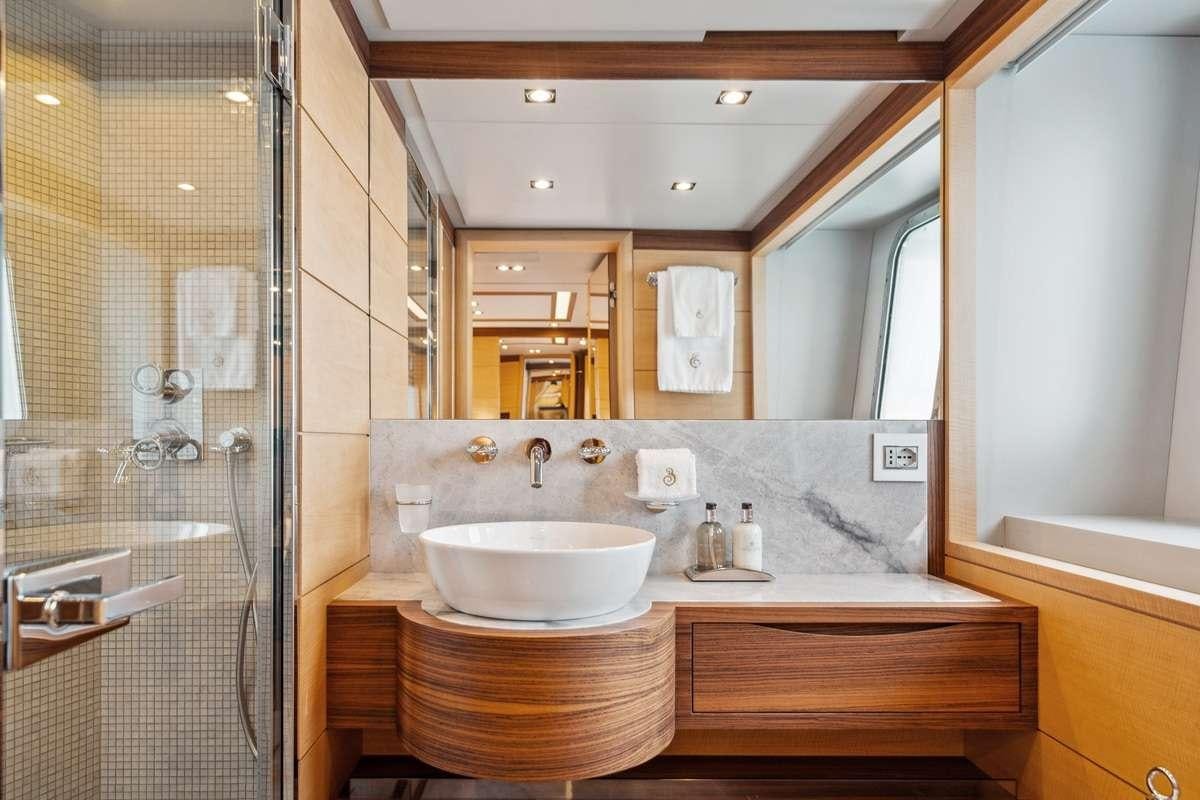 a bathroom with a sink and a mirror aboard BOMBAY Yacht for Charter