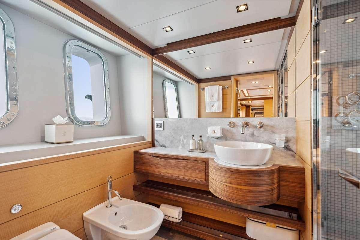 a bathroom with a sink and a mirror aboard BOMBAY Yacht for Charter