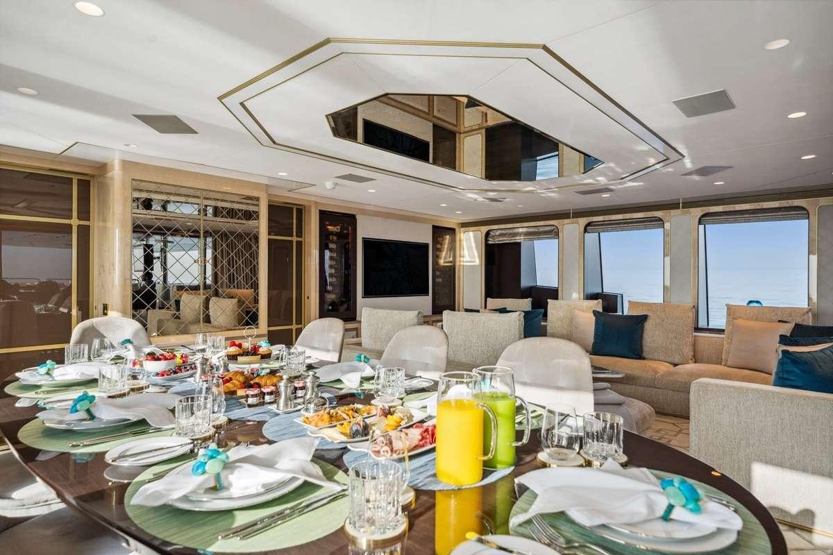 a dining room with a table set for a meal aboard BOMBAY Yacht for Charter