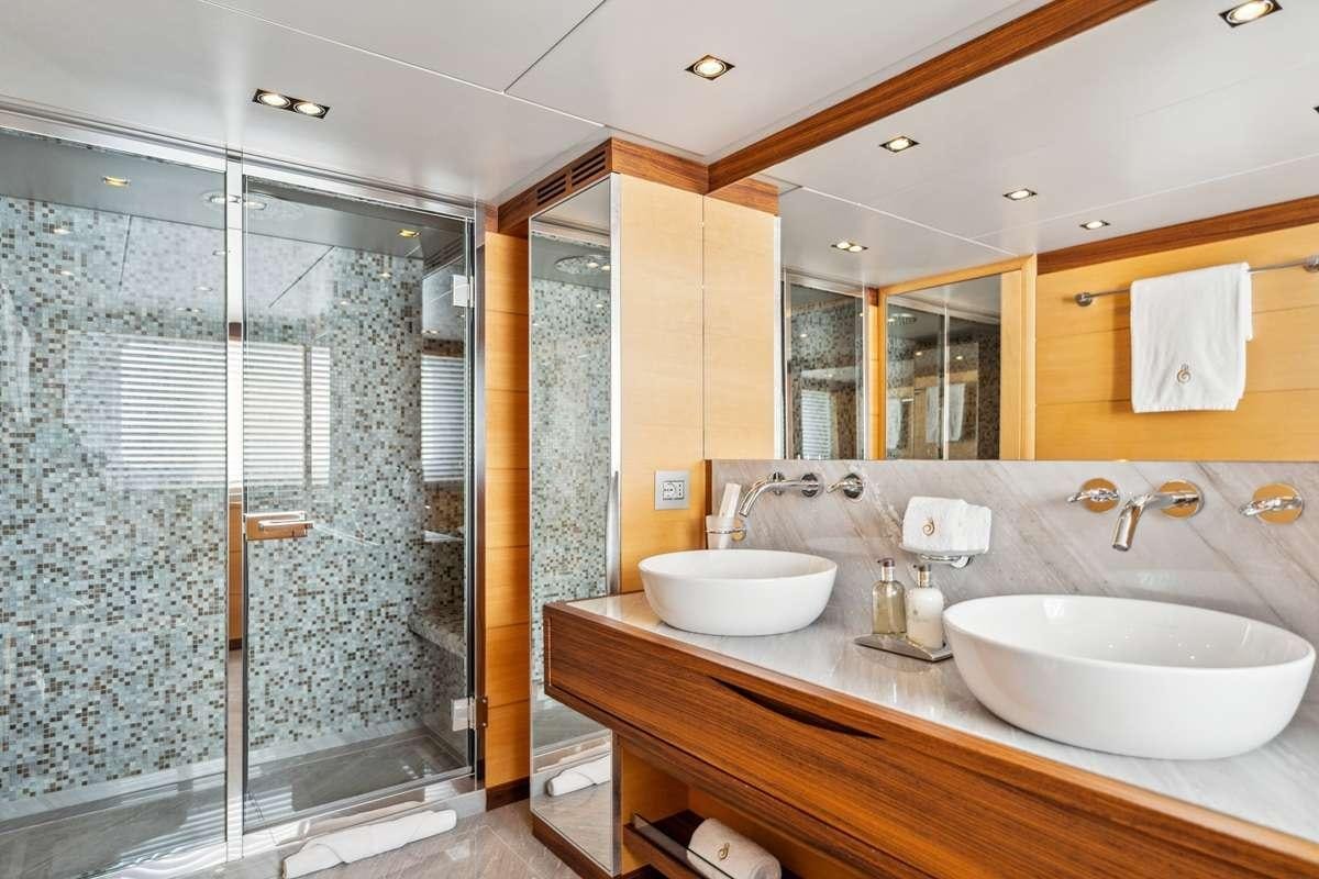 a bathroom with a glass shower aboard BOMBAY Yacht for Charter