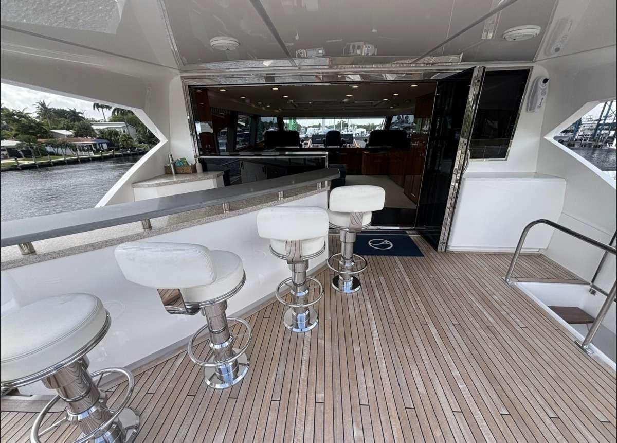 a room with tables and chairs aboard INDIGO Yacht for Charter