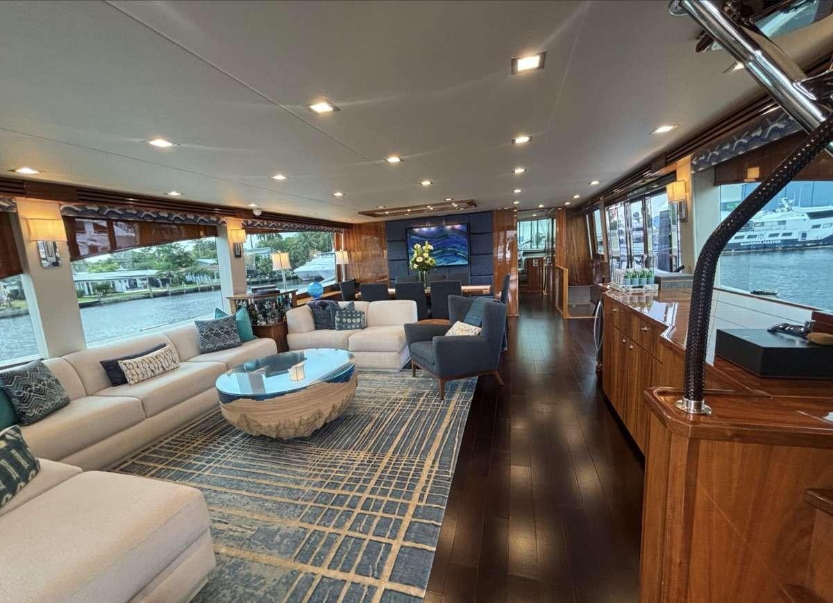 a living room with a large window aboard INDIGO Yacht for Charter