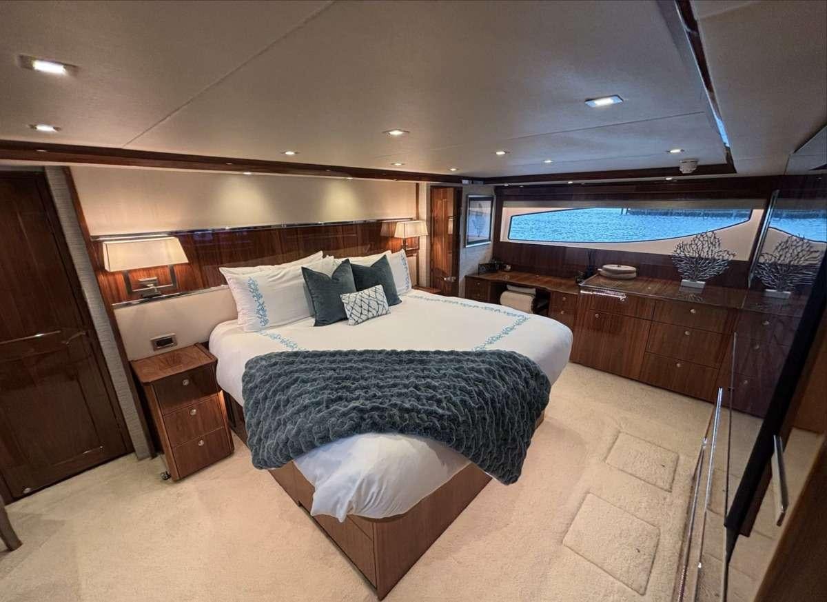 a hotel room with a large bed aboard INDIGO Yacht for Charter