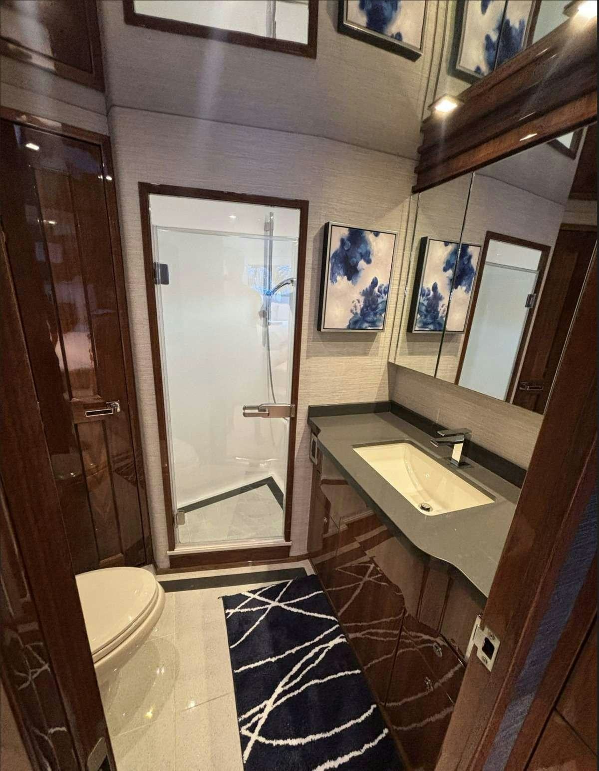 a bathroom with a sink and a mirror aboard INDIGO Yacht for Charter