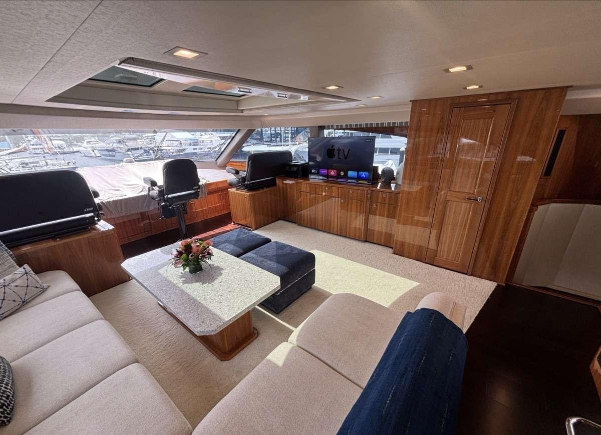a room with a couch and a table and chairs aboard INDIGO Yacht for Charter