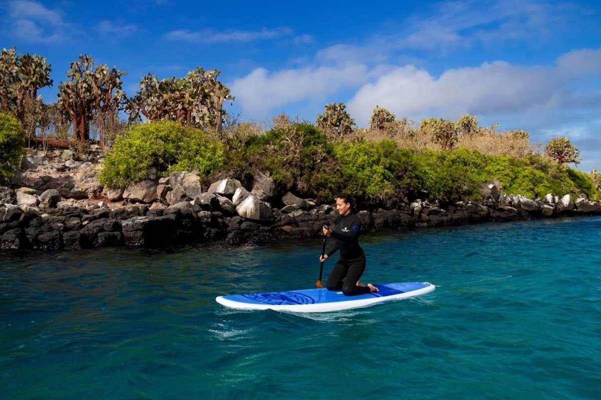 a man on a surfboard in the water aboard GALAPAGOS ANGEL Yacht for Charter