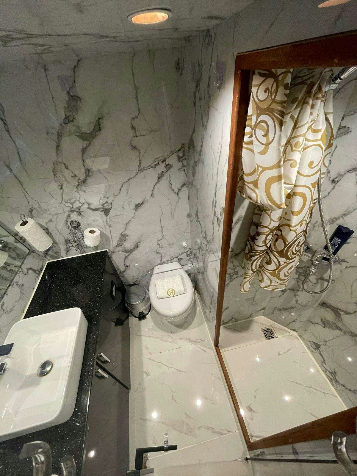 a bathroom with a toilet and bathtub aboard BEYEFENDI H Yacht for Charter