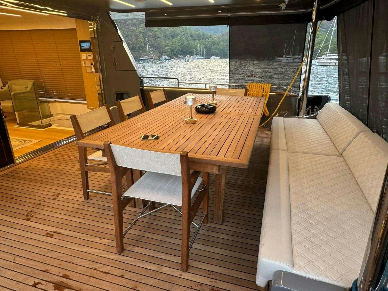 a table with chairs on it aboard BEYEFENDI H Yacht for Charter