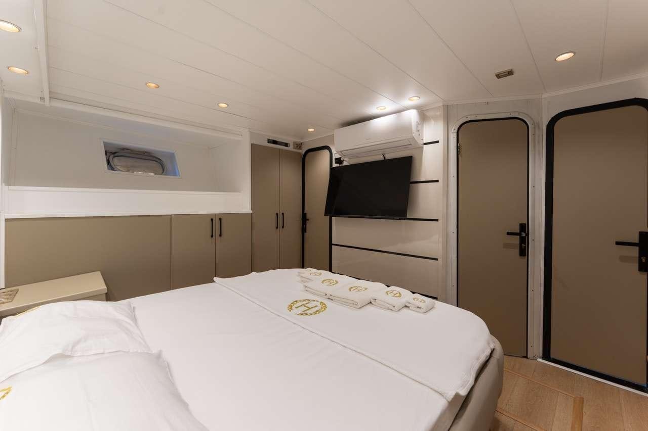 a room with a bed and a closet aboard BEYEFENDI H Yacht for Charter
