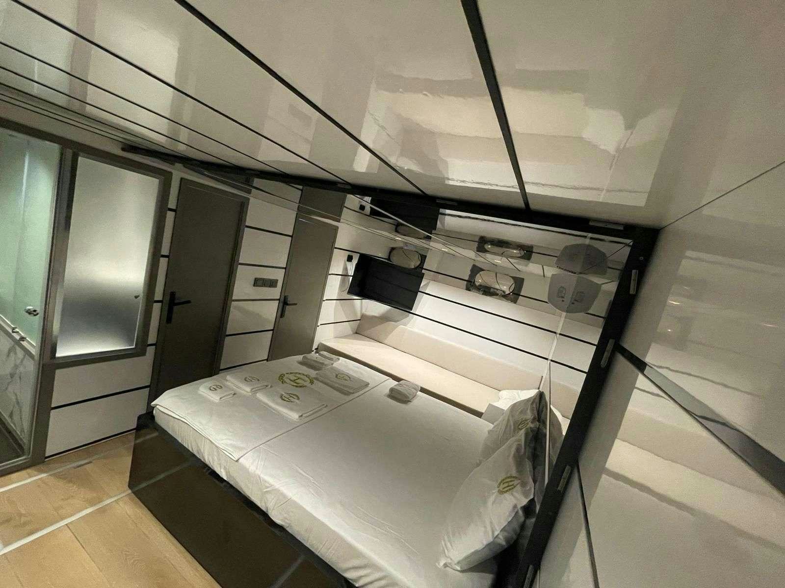 a room with a bed and a desk aboard BEYEFENDI H Yacht for Charter