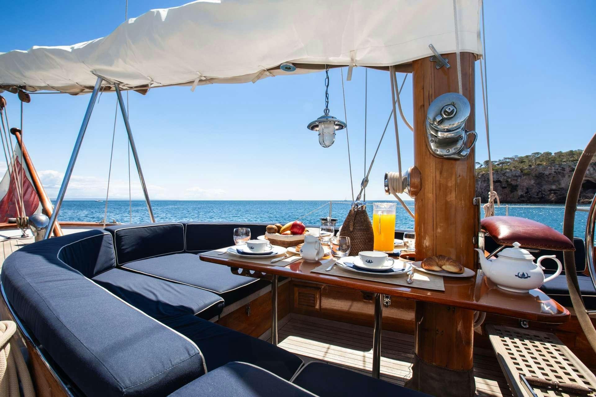 a boat with a table and chairs aboard GAEL I Yacht for Charter