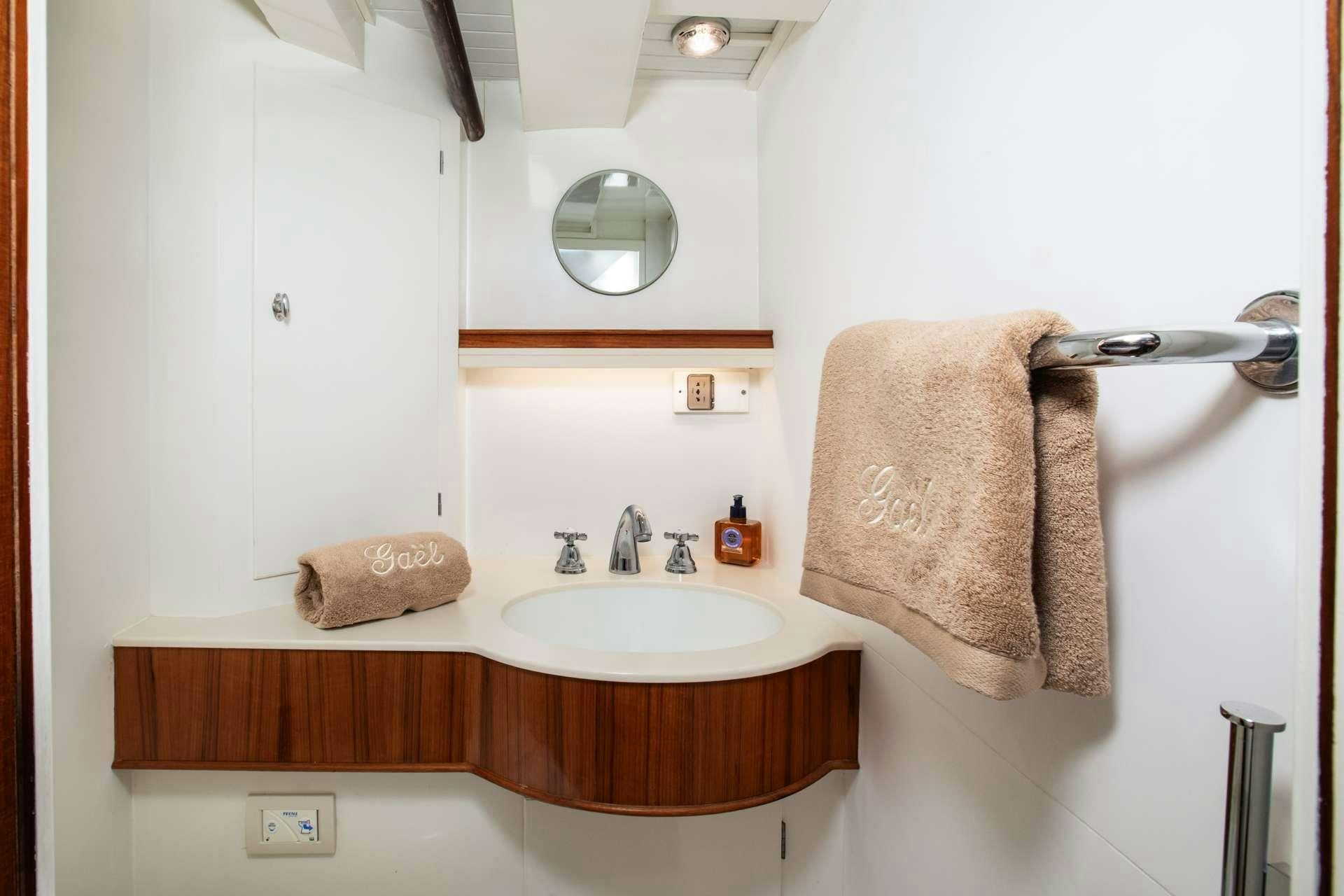 a bathroom with a sink and towels aboard GAEL I Yacht for Charter