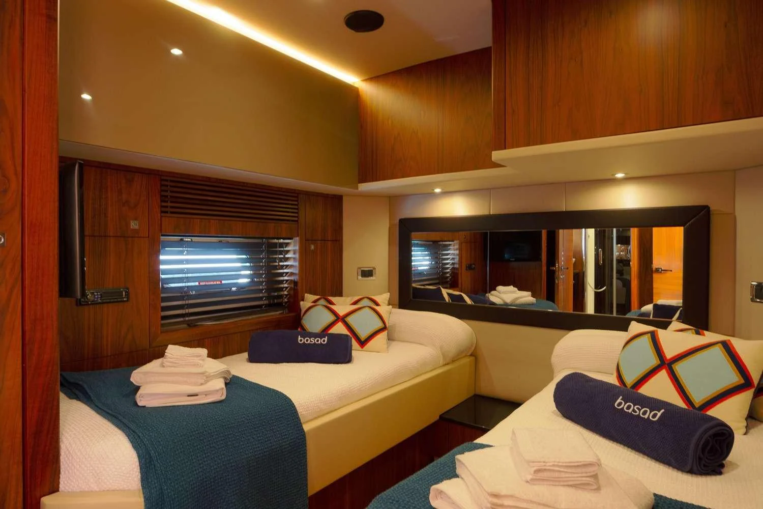 a room with a bed and a television aboard BASAD Yacht for Charter