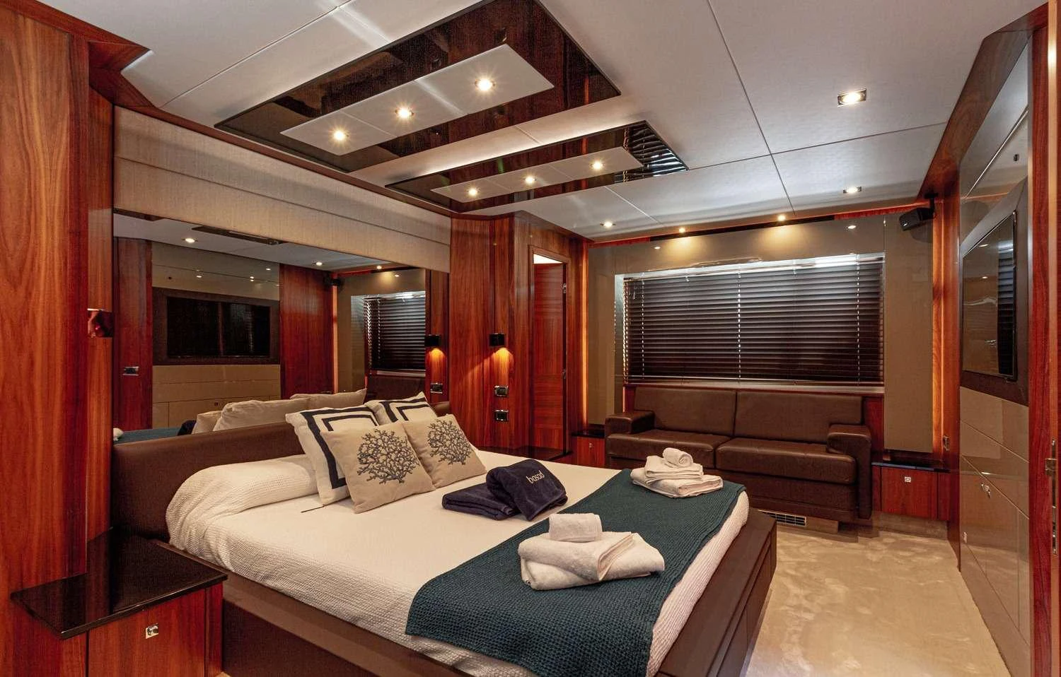 a large bedroom with a bed and a couch aboard BASAD Yacht for Charter