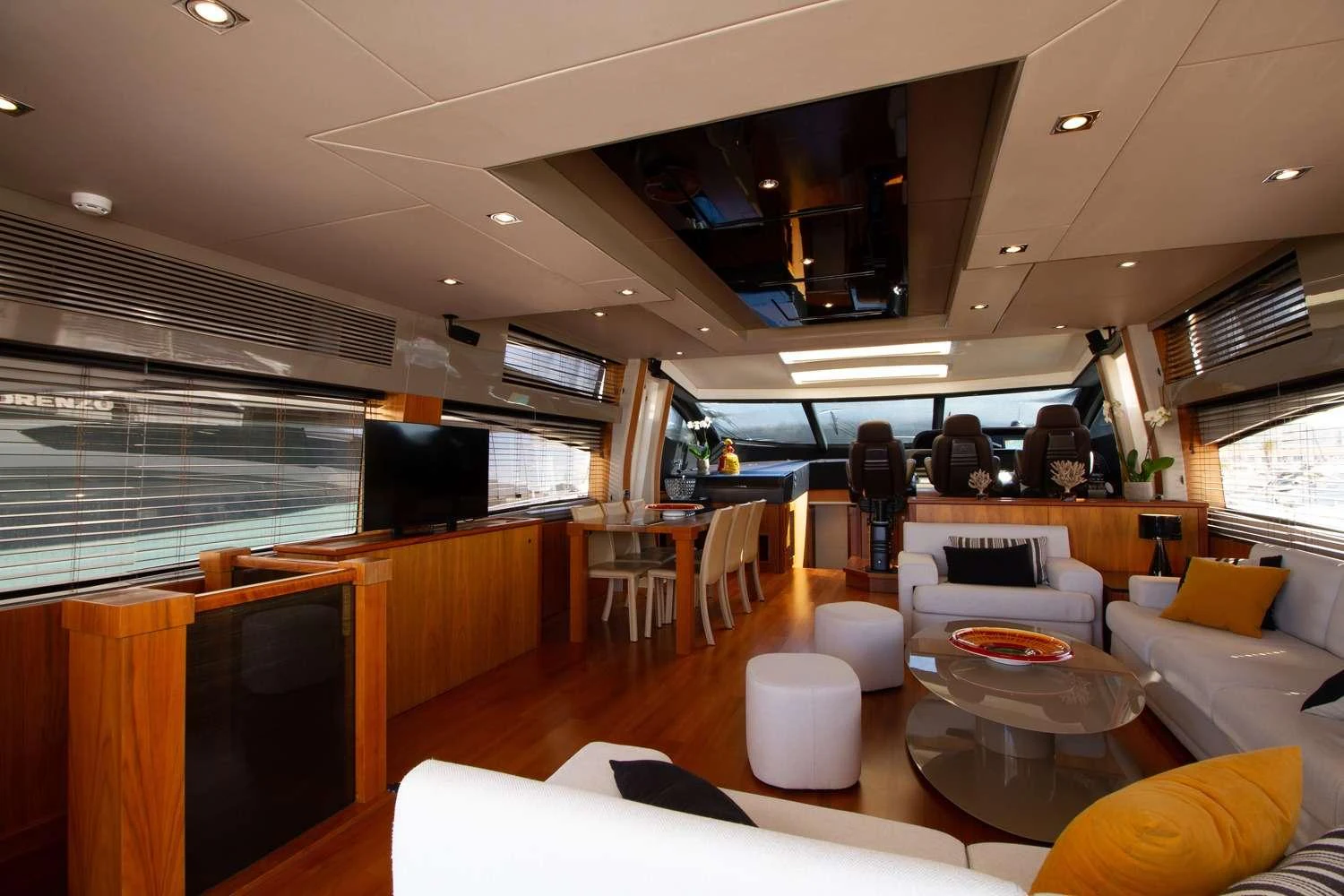 a room with a table chairs and a window aboard BASAD Yacht for Charter