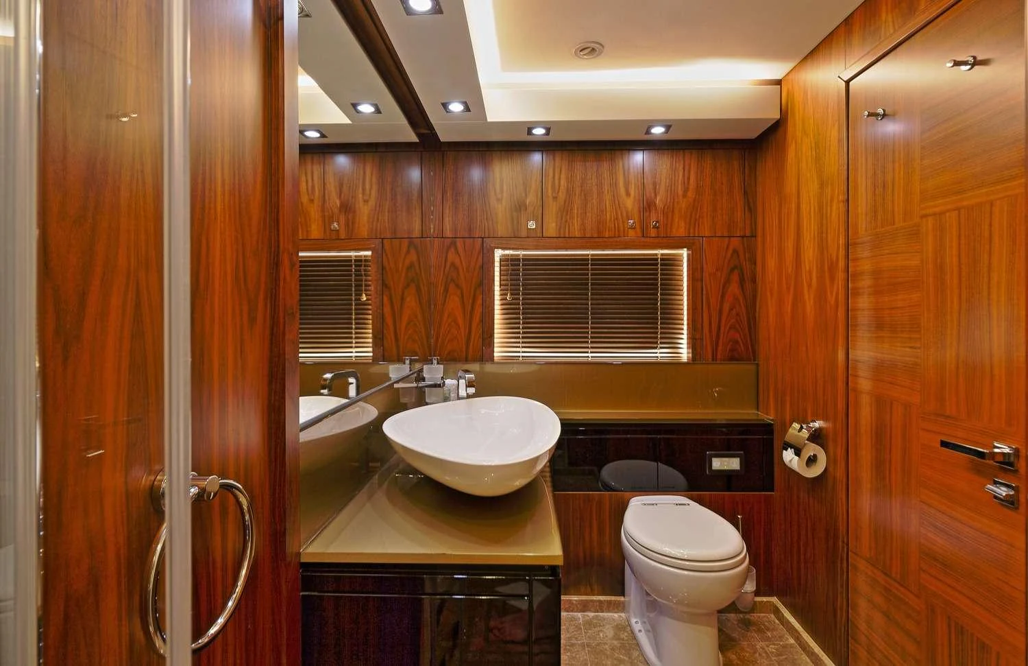 a bathroom with wooden cabinets aboard BASAD Yacht for Charter