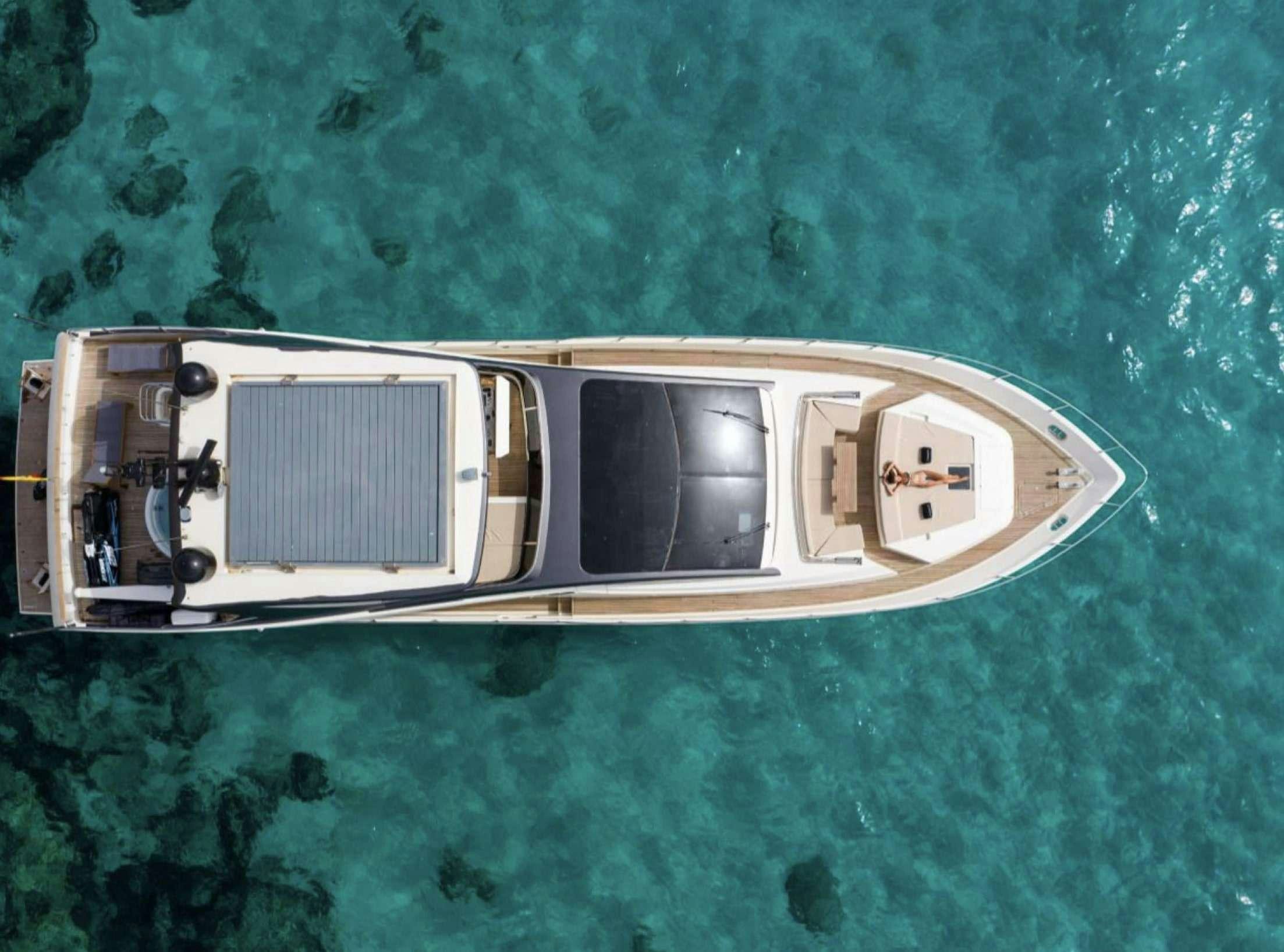 a white rectangular object with a silver square on a green surface aboard BISCAYNE Yacht for Charter