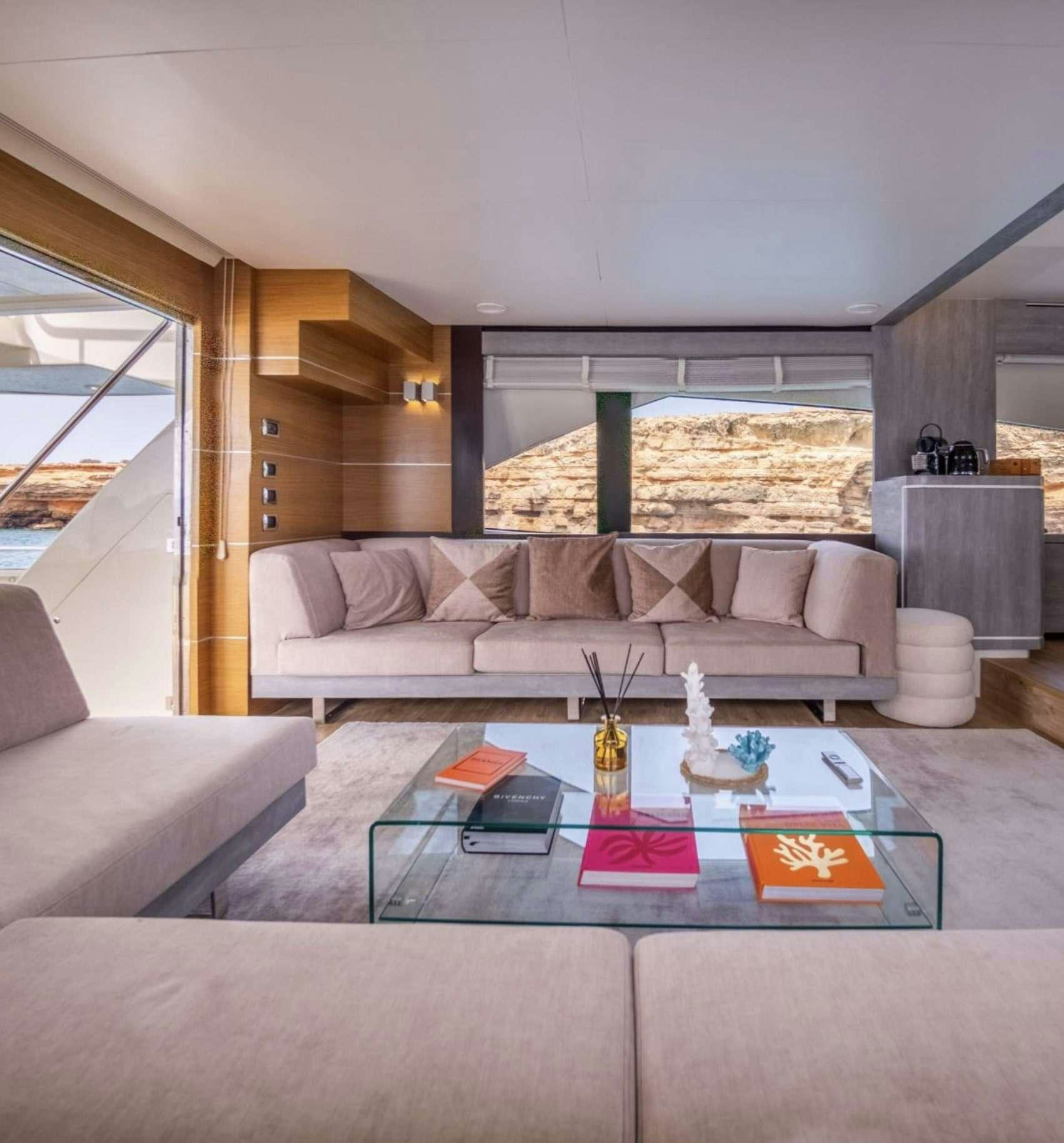 a living room with a couch and a coffee table aboard BISCAYNE Yacht for Charter