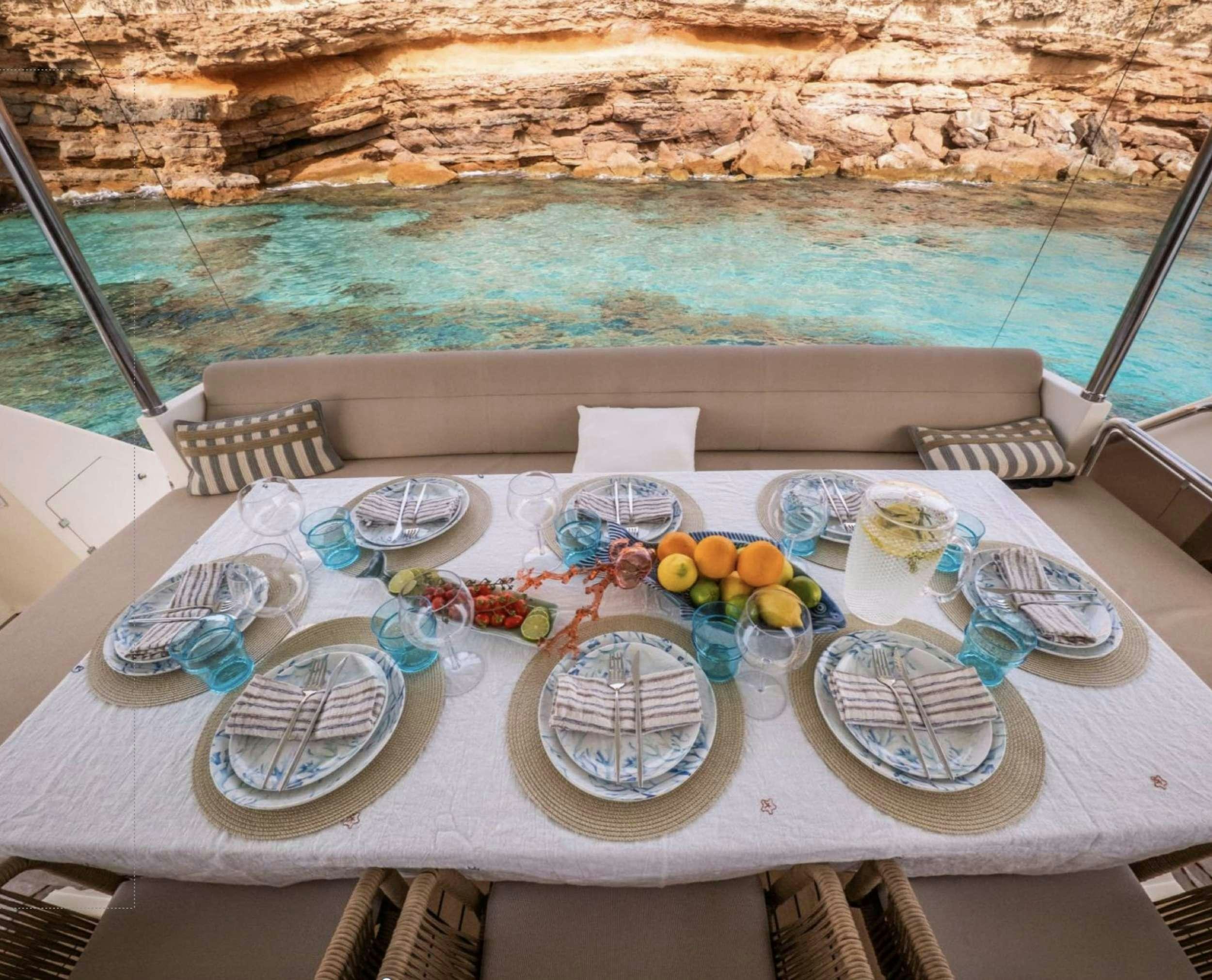 a table with plates and food on it aboard BISCAYNE Yacht for Charter
