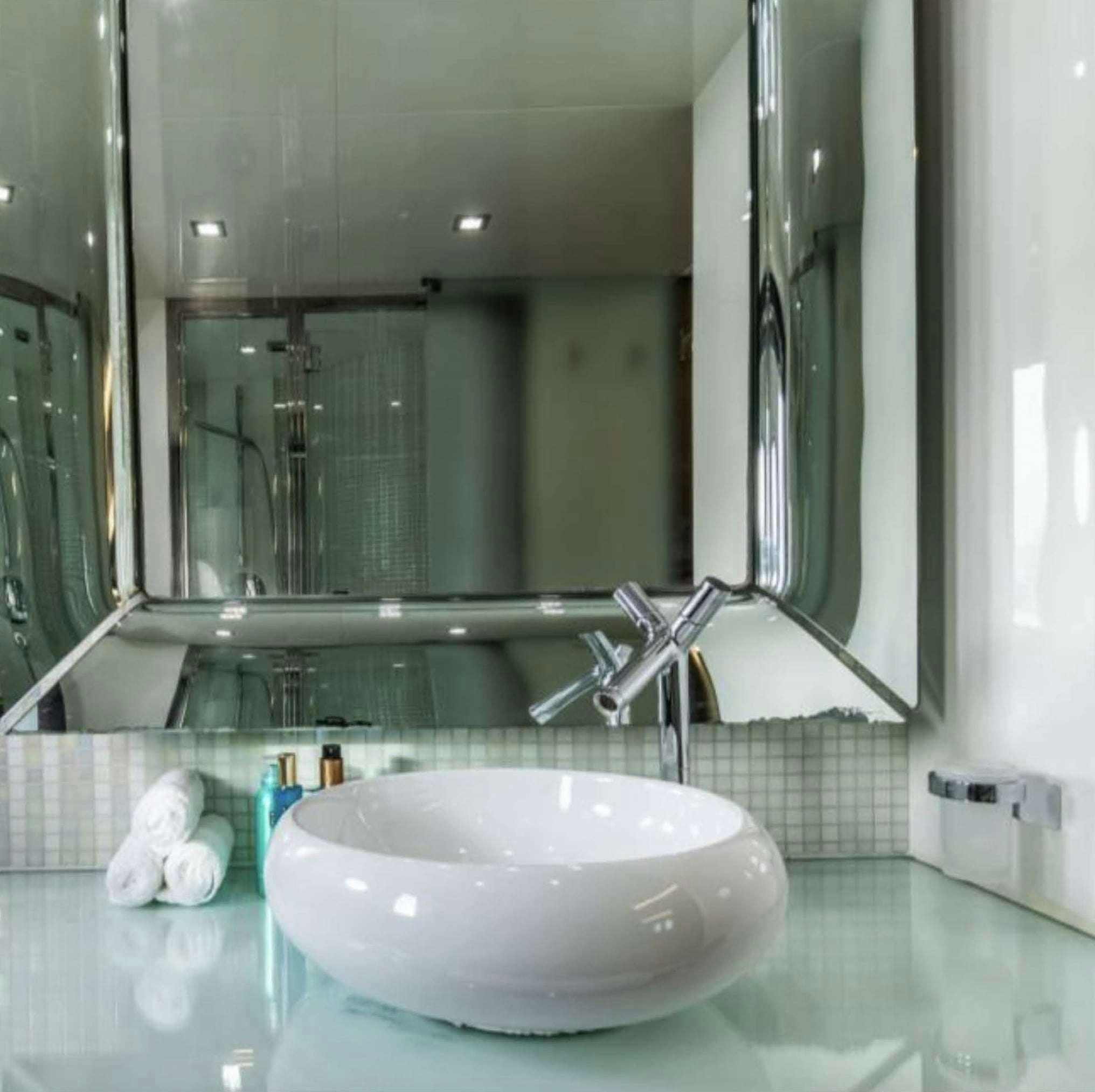a bathroom sink with a large mirror aboard BISCAYNE Yacht for Charter
