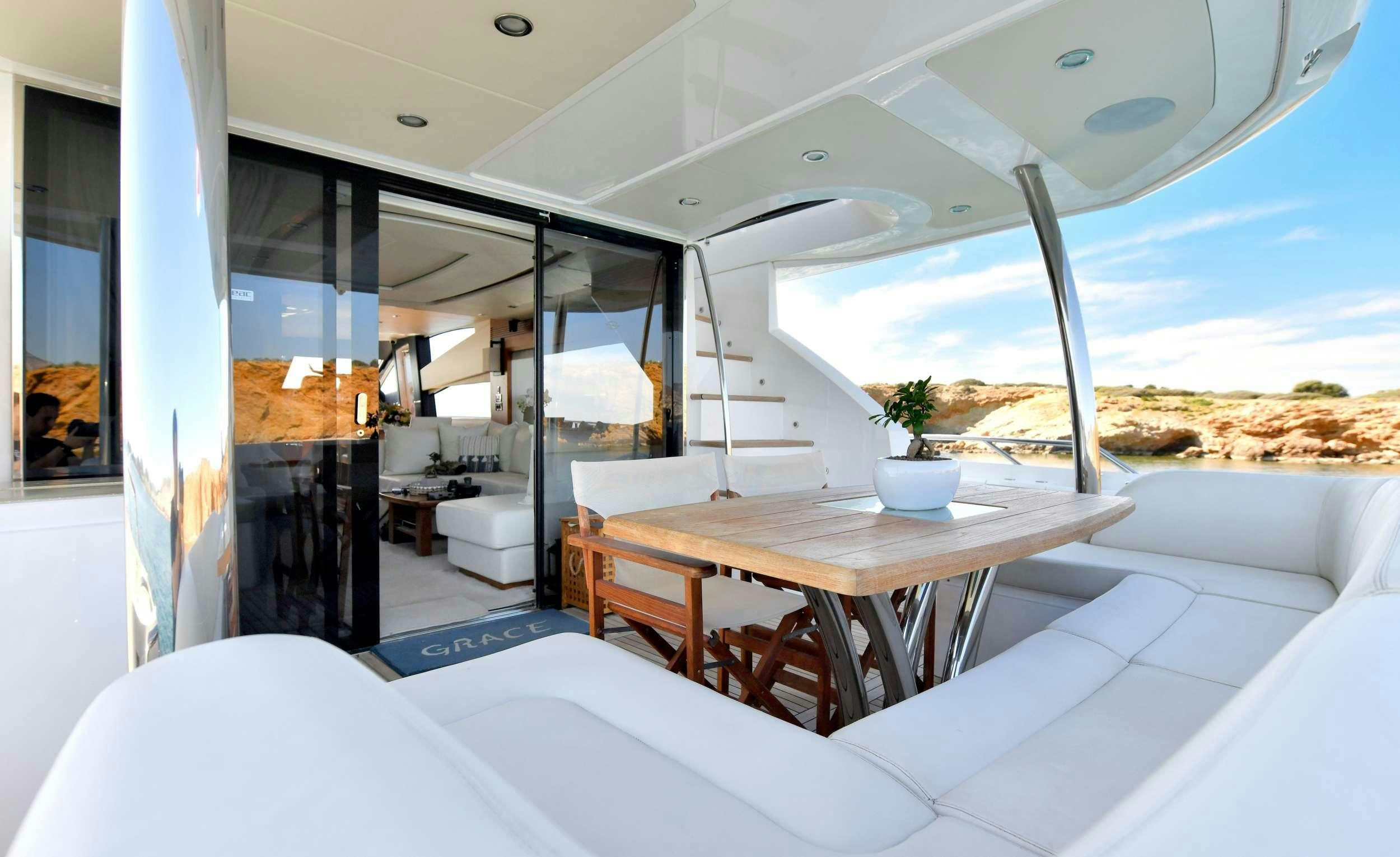 a room with a table and chairs aboard GRACE XI Yacht for Charter