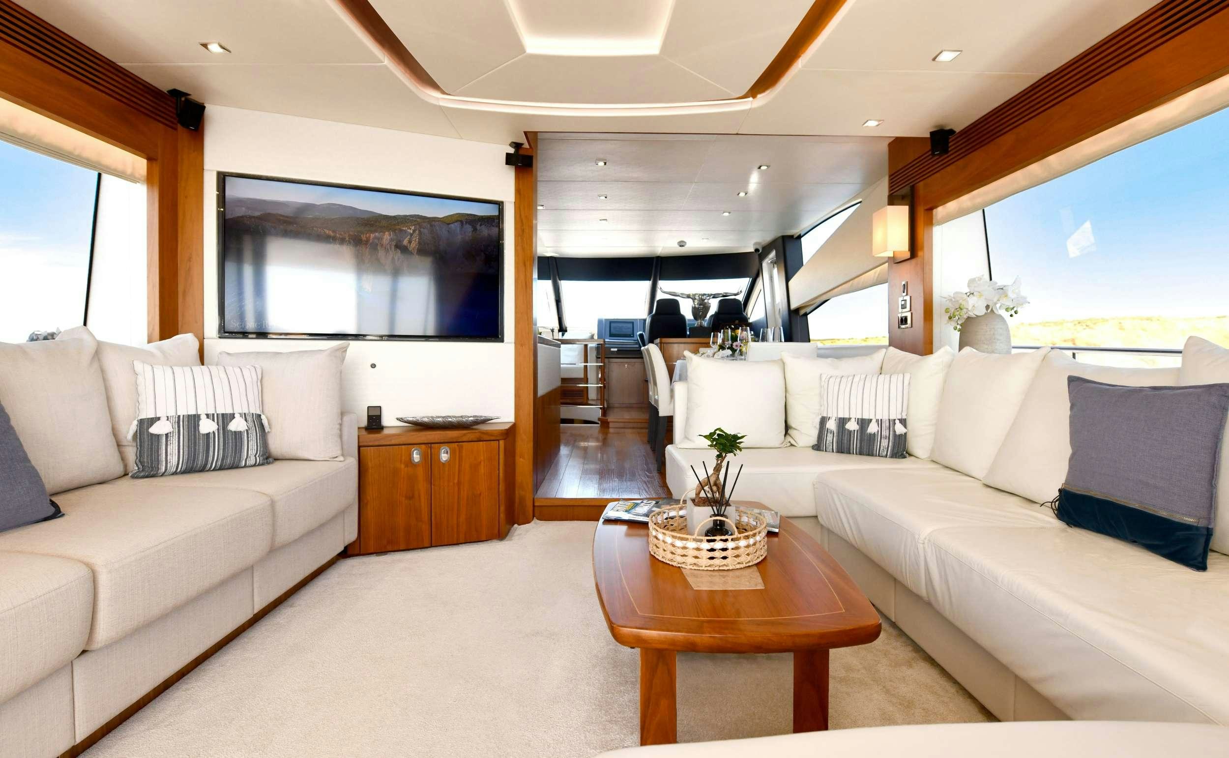 a living room with a large window aboard GRACE XI Yacht for Charter