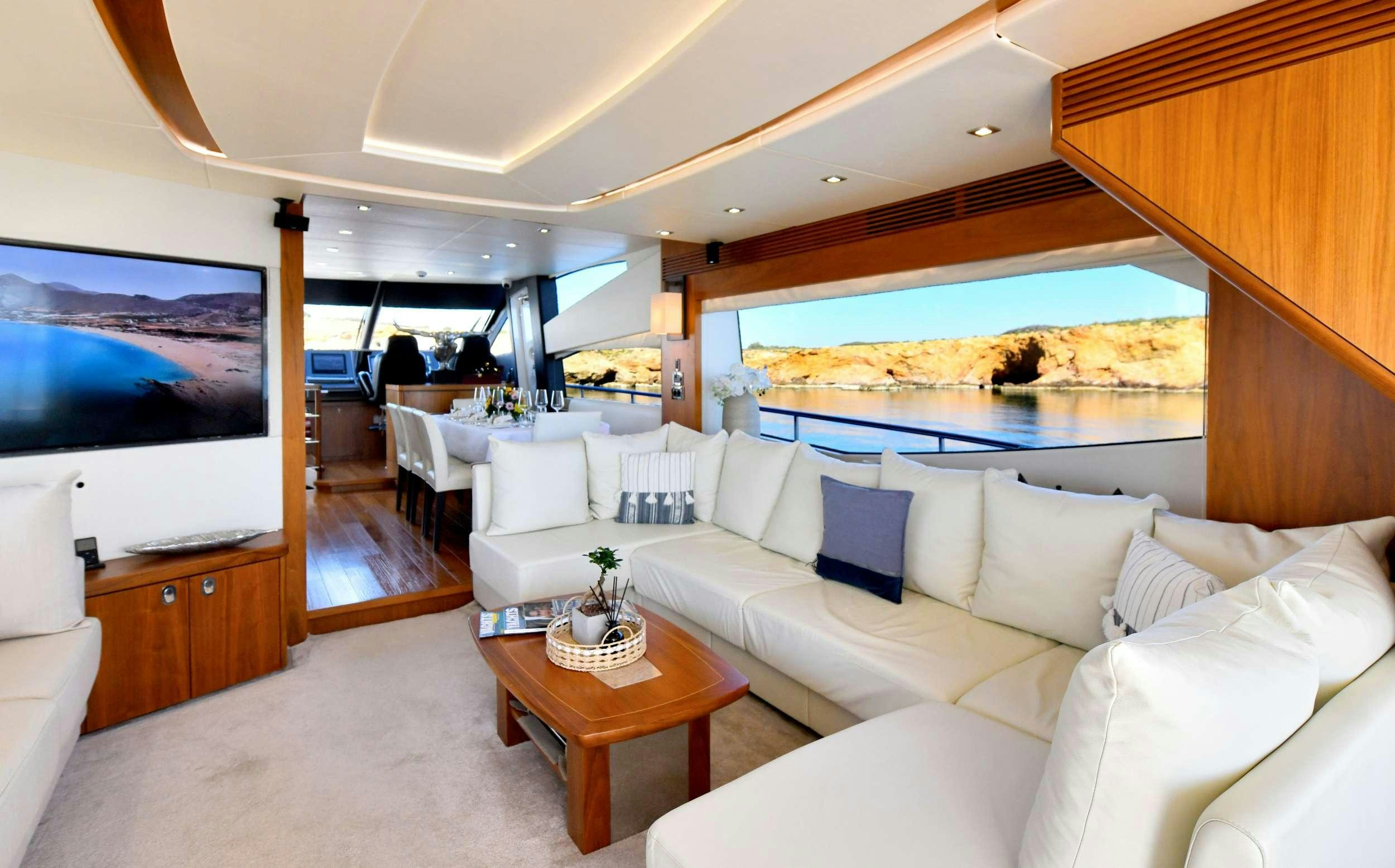 a living room with a large window aboard GRACE XI Yacht for Charter