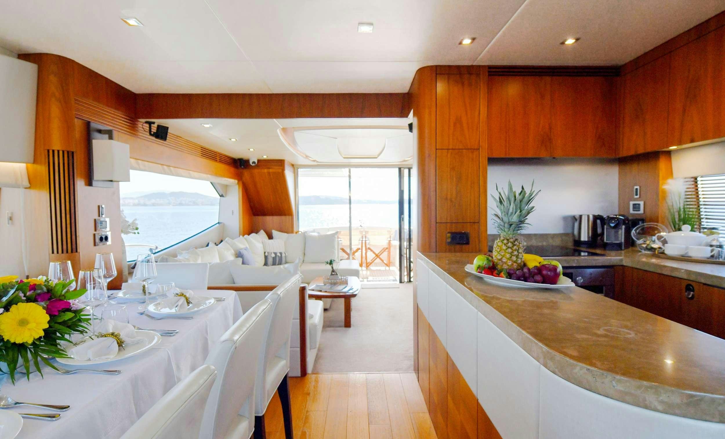 a kitchen with a table and chairs aboard GRACE XI Yacht for Charter