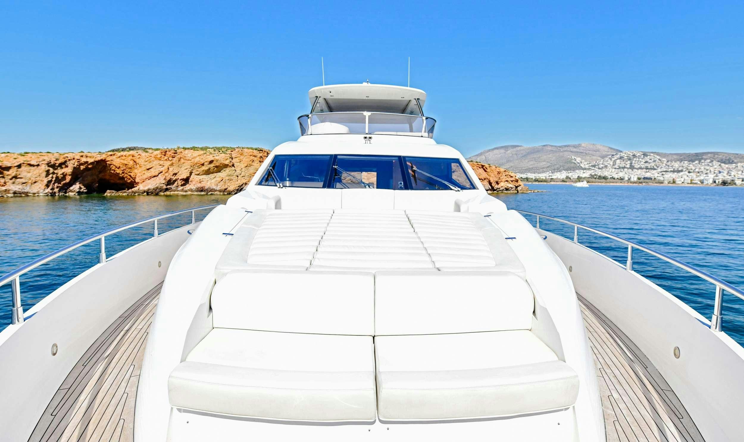 a white boat on a body of water aboard GRACE XI Yacht for Charter