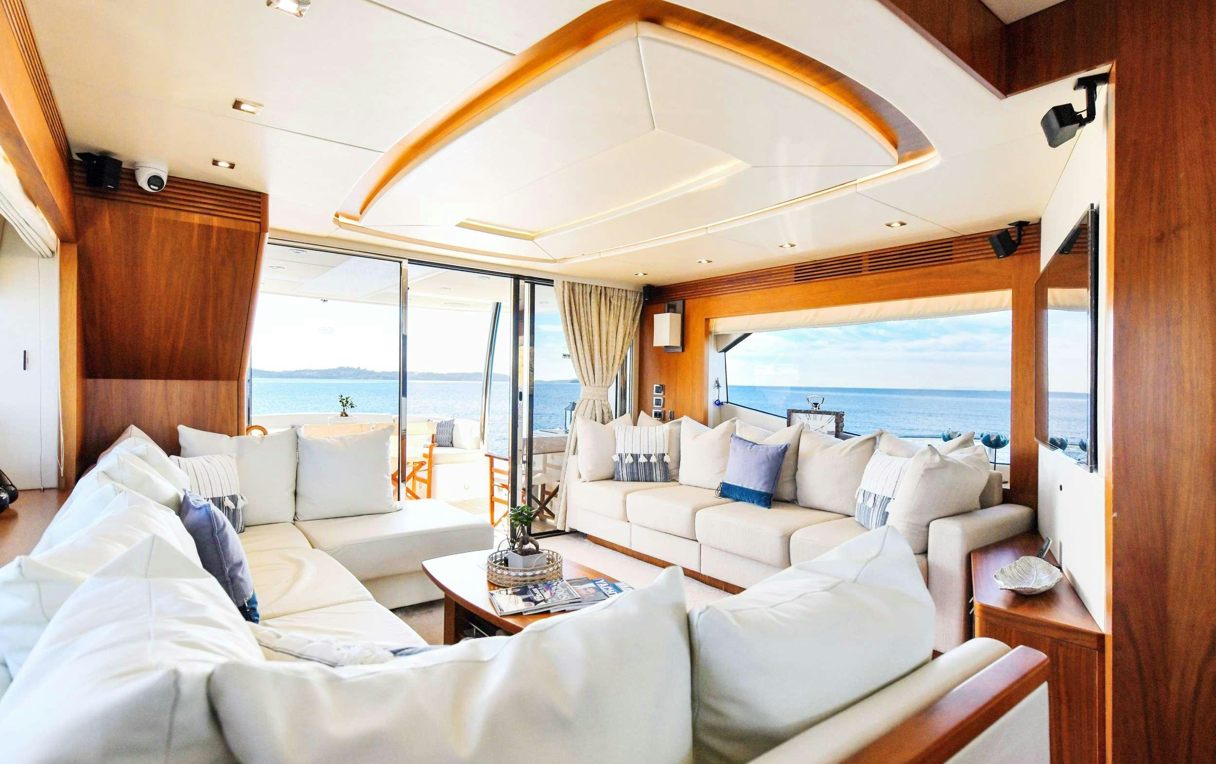 a room with a bed and a large window aboard GRACE XI Yacht for Charter