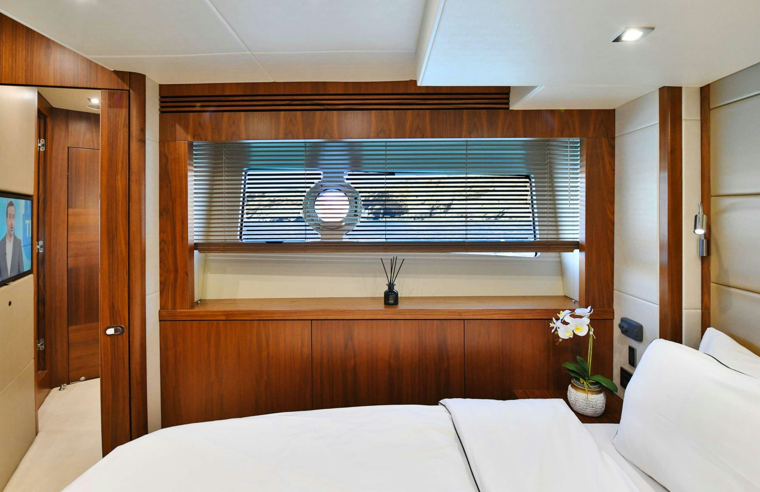 a room with a bed and a window aboard GRACE XI Yacht for Charter