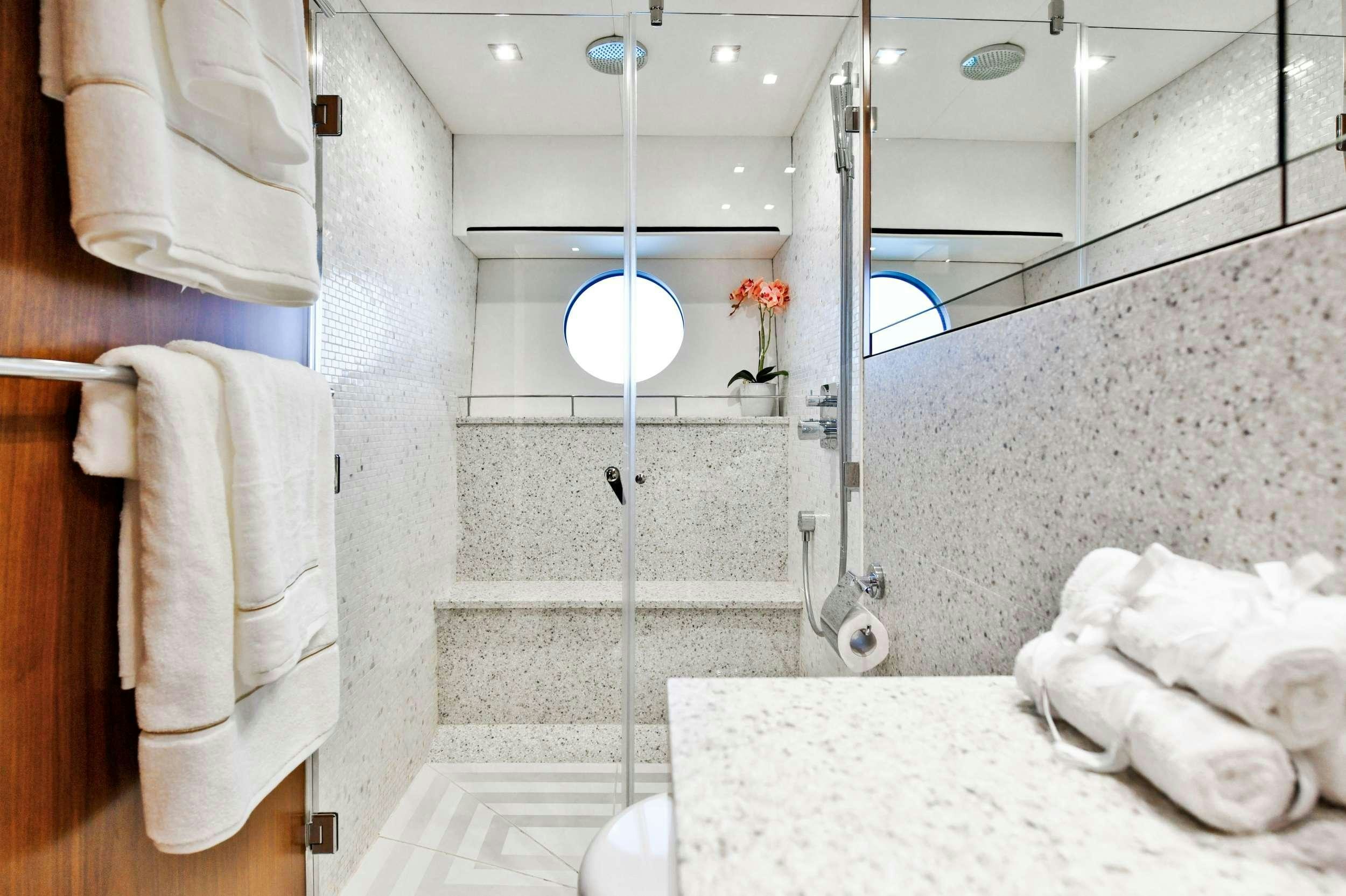a bathroom with a mirror and towels aboard GRACE XI Yacht for Charter
