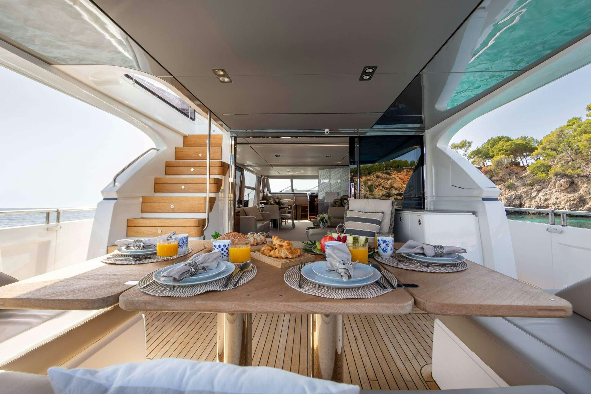 a table with plates and food on it aboard MIO BARCO Yacht for Charter